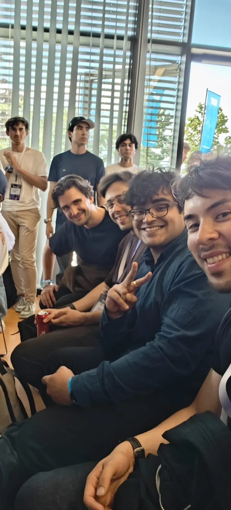 The team sitting together in the venue, grinning at the camera