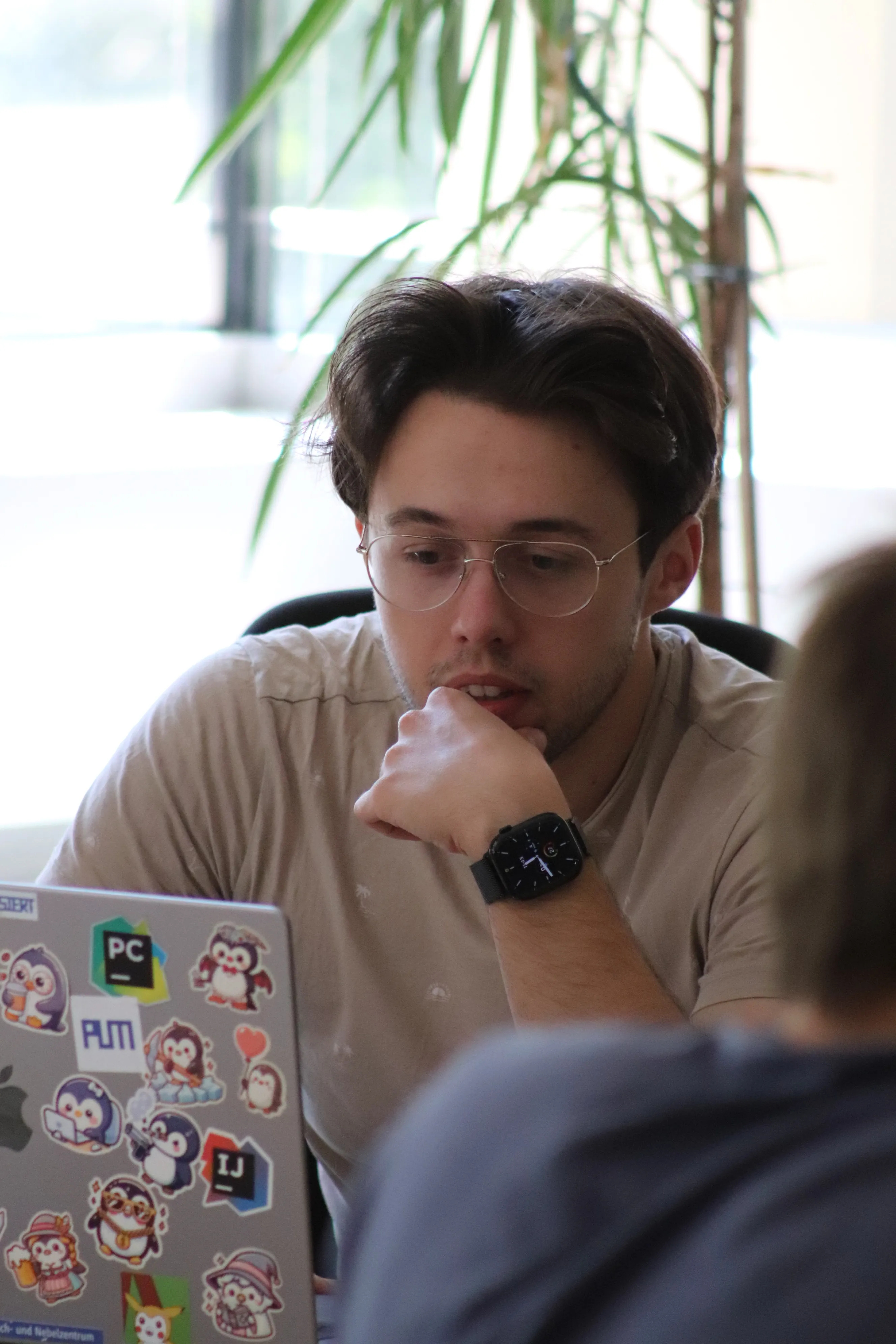 Close-up of team members working on the hackathon project, with Justin Lanfermann in the center